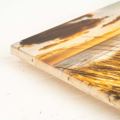 Fotodruck von einer Aufnahme am Strand beim Sonnenuntergang auf Holzlatten. Sichtbare Lattenstruktur am Rand.