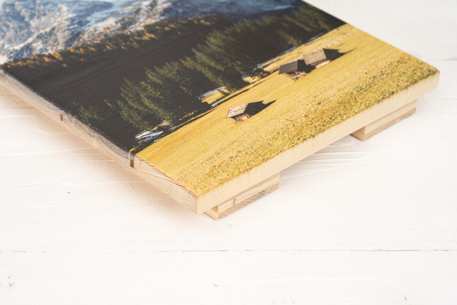Fotodruck auf Holzlatten. Man sieht die separaten Latten von der Seite, sowie das Holz, was die Latten hinten verbindet und von unten rausschaut.